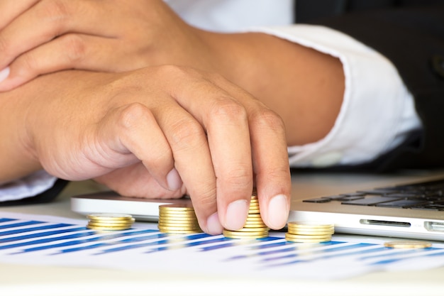 Businessman working with golden coin.