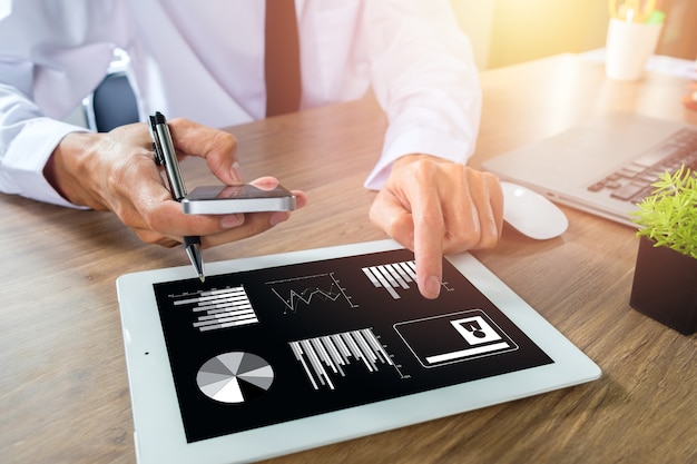 Businessman working with smart phone and digital tablet and laptop computer