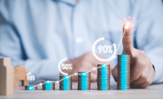 Businessman writing chart on growth coin stacking with virtual circle percentage loading