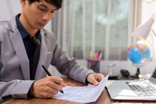 Businessman writing documents signing documents