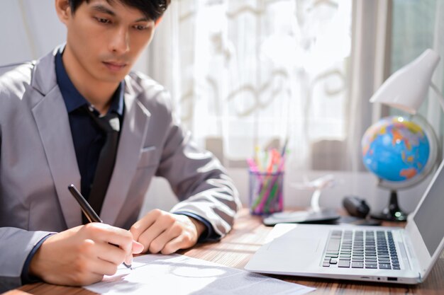 Businessman writing documents signing documents