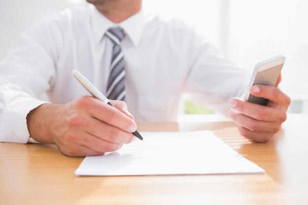 Businessman writing on a paper