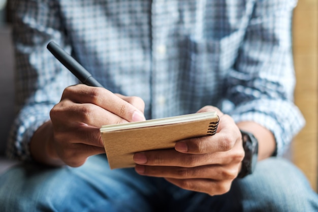 Businessman writing something on notebook in office 