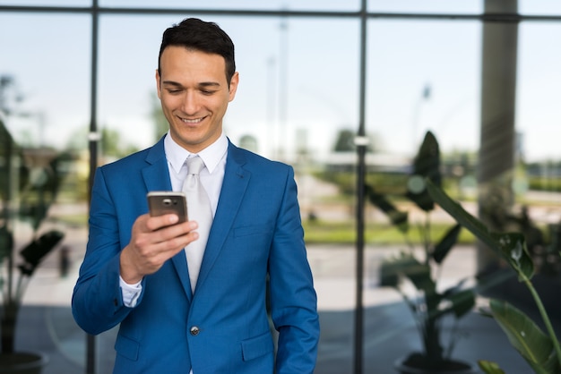 Businessman writing a text message