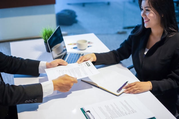 Businessmen and Businesswomen discussing documents for job interview concept