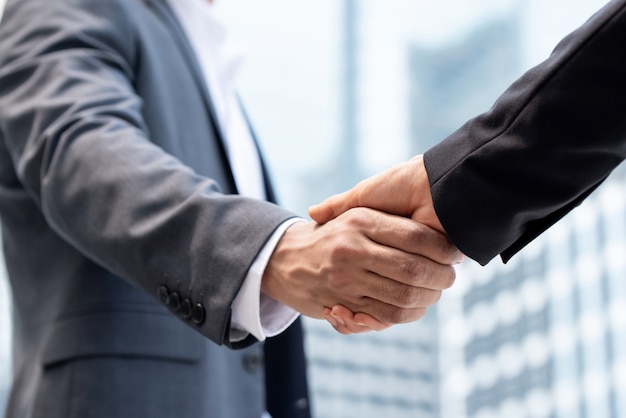 Businessmen making handshake in the city 