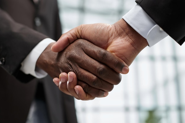 Businessmen reach out to each other to shake hands