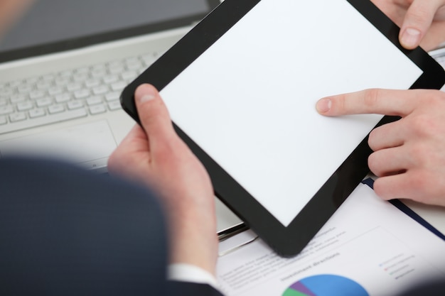 Businessmen reading financial review at tablet pc