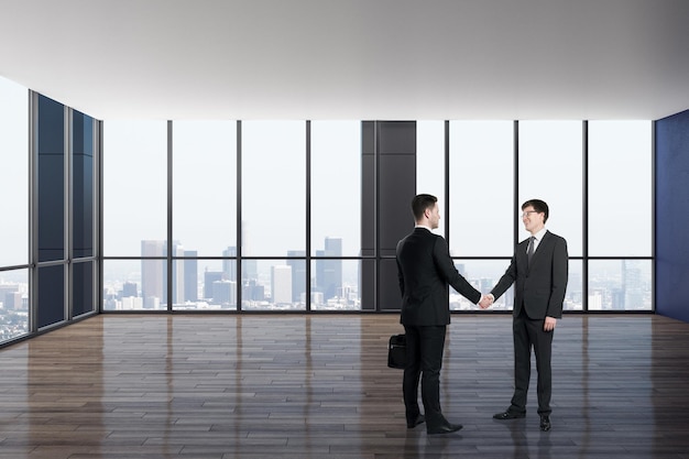 Businessmen shaking hands in luxury office interior