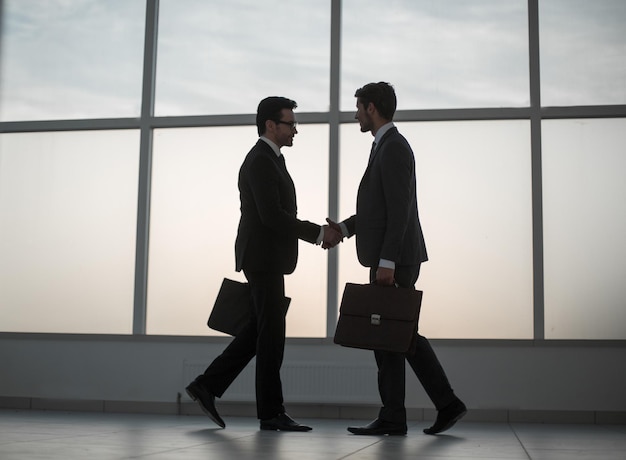 Businessmen stretching out their hands for a handshake