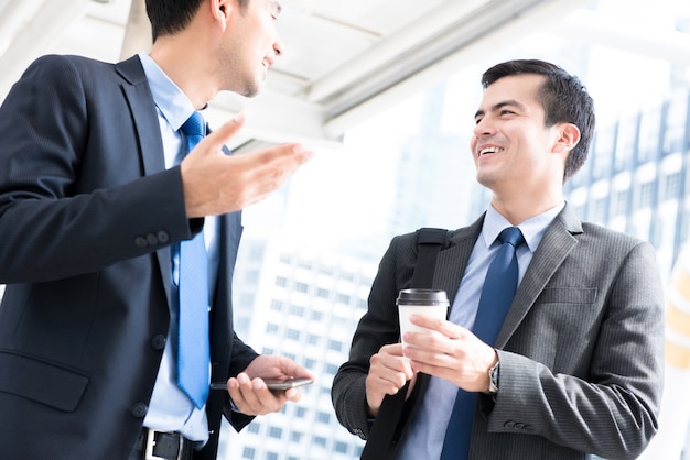 Businessmen talking while walking to work in the morning