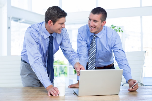 Businessmen using laptop