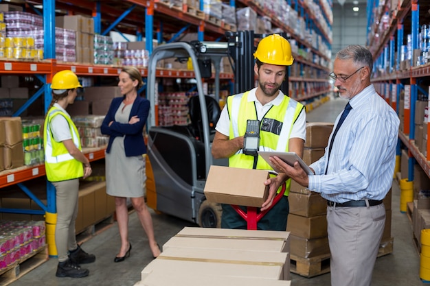 Businessmen and warehouse workers