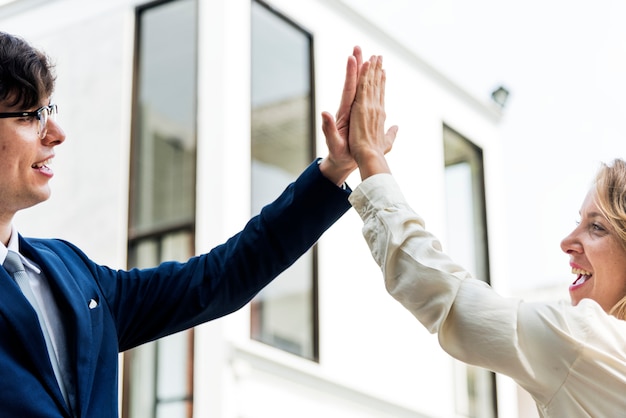 Businesspeople giving a high five together