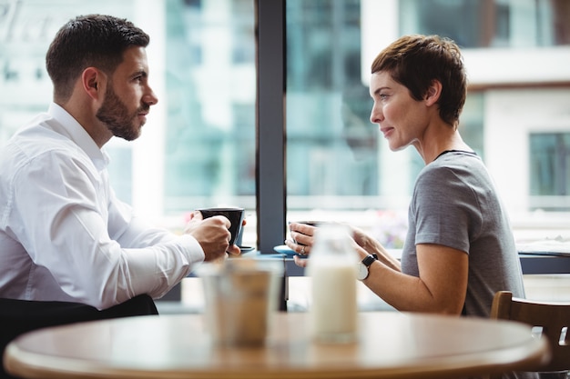 Businesspeople interacting while having coffee