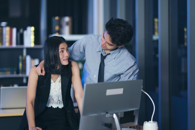 Businesspeople in the office at night working late