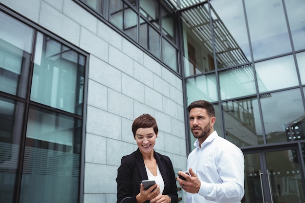 Businesspeople using mobile phone