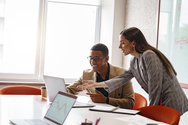 Businesspeople working together in modern coworking sitting at desk