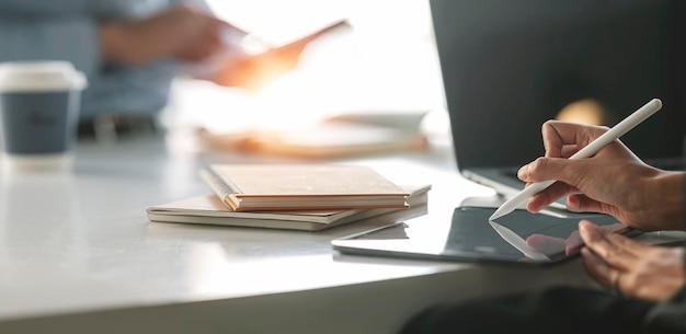 Businessperson Analyzing business information On Digital Tablet at office