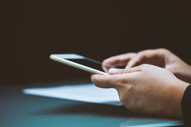 Businessperson working on digital tablet with graph data document on desk