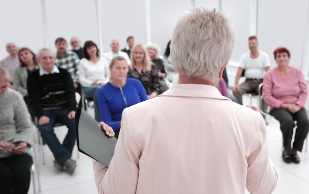 Businesswoman addressing colleagues at office meeting