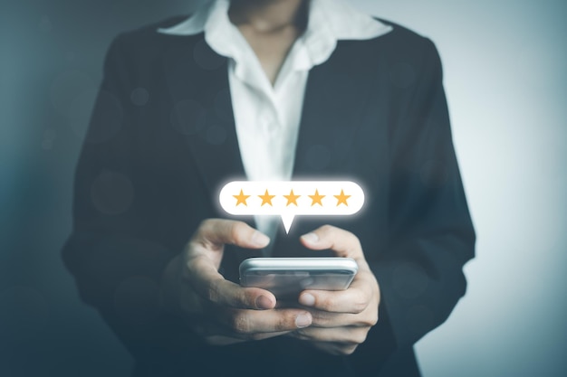 Businesswoman assess service satisfaction 5 stars by smartphone Corporate care high standard