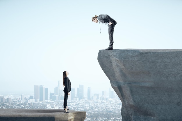 Businesswoman and businessman standing on mountain