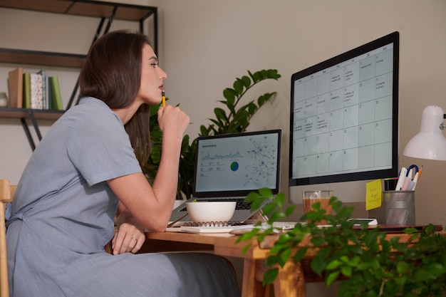 Businesswoman Checking Calendar on Screen