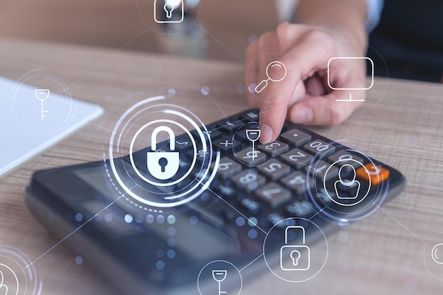 A businesswoman computing probability of risks in cyber security protection using calculator Padlock Hologram icons over the working desk Formal wear