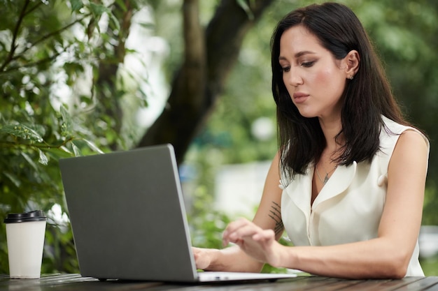 Businesswoman Concentrated on Answering Emails