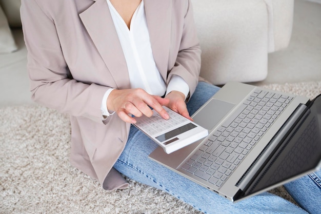 a businesswoman considers the budget or money on a calculator and works with a laptop Accounting