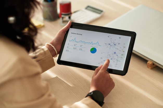 Businesswoman examining charts on tablet pc