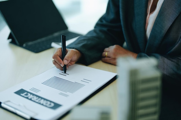 A businesswoman or a female business owner signs important documents to borrow money for investment in real estate or homes with the bank