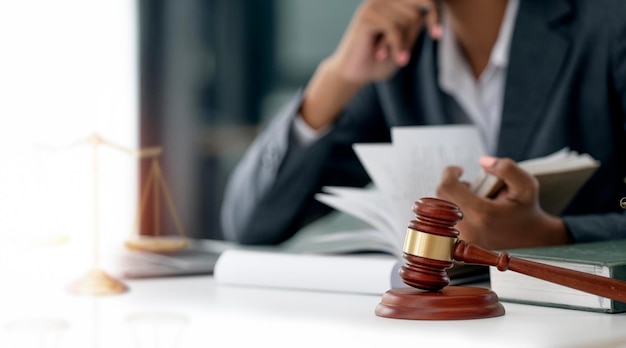 Businesswoman female lawyer reading book wooden judge gavel on the table