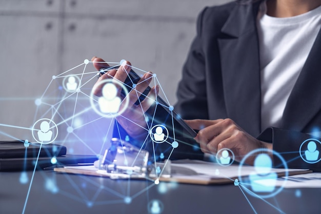 Businesswoman in formal wear checking the phone to sign the employment agreement to boost her career and gain new opportunities in personal growth Concept of success Social media hologram icons