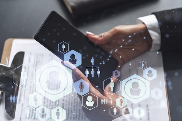 Businesswoman in formal wear checking the phone to sign the employment agreement to boost her career and gain new opportunities in personal growth Concept of success Social media hologram icons