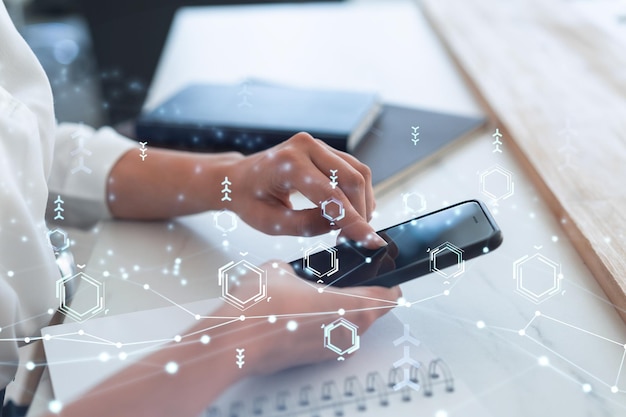 Businesswoman in formal wear holding in the hands a smart phone and testing an innovative application to provide a completely new service Close up shot Hologram tech graphs Concept of Dev team