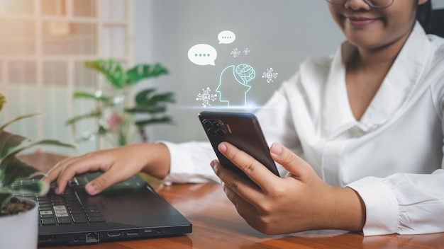 Businesswoman hand uses a smartphone to type live chat ask answer with an artificial intelligence system chat bot Ai