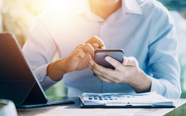 Businesswoman hand working with laptop computer tablet and smart phone in modern office with virtual icon diagram at modernoffice in morning light