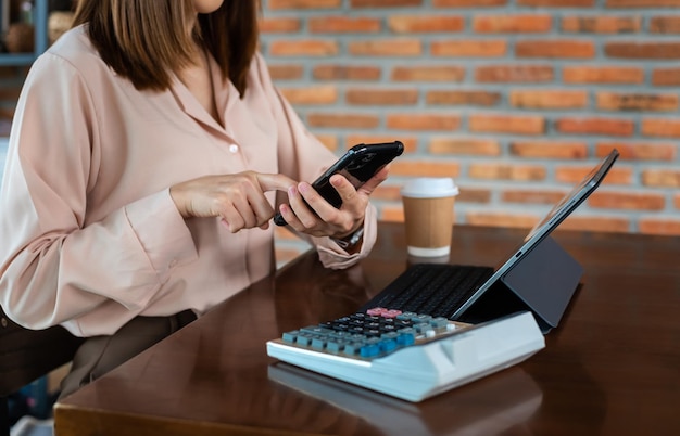 Businesswoman hand working with new modern computer using on smartphone and tablet as concept