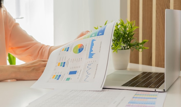 Businesswoman hands hold documents with financial statistic stock photodiscussion and analysis data the charts and graphs