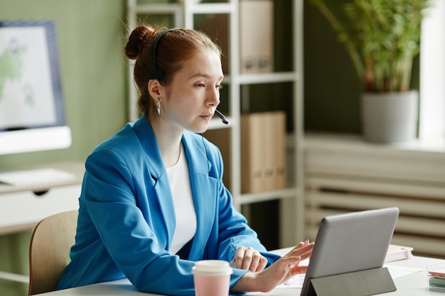 Businesswoman having online meeting on tablet pc