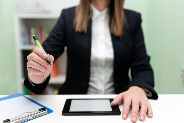 Businesswoman Having Tablet On Desk And Pointing Important Ideas With Pencil Woman With Phone Showing Recent Updates Executive Displaying Late News