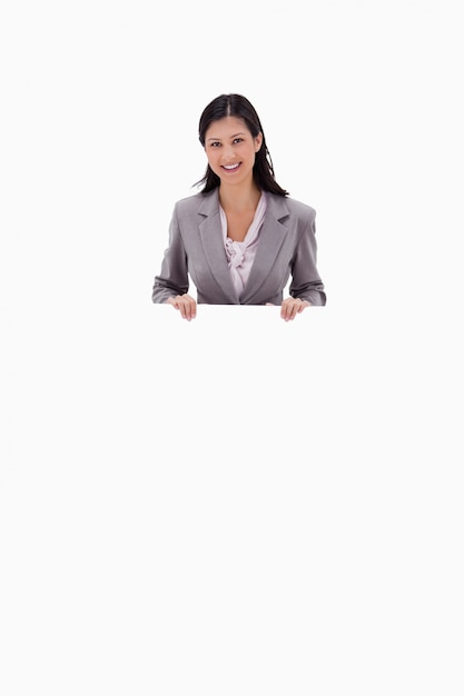 Businesswoman holding blank sign board