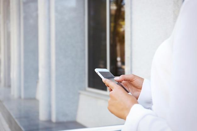 Businesswoman holding cellphone closeup