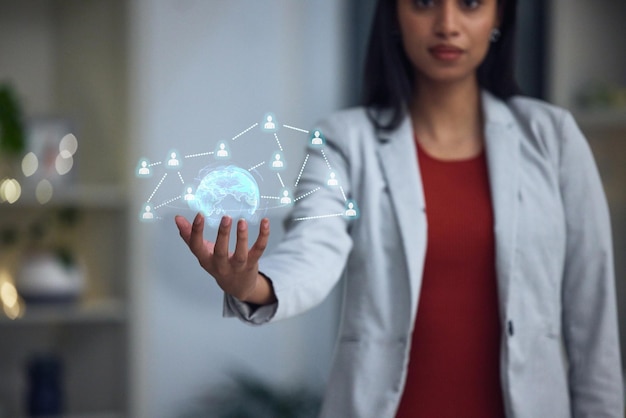 Businesswoman holding a digital globe tech and networking at the office in the future Big data ai and a virtual sphere and social hologram showing connections between people