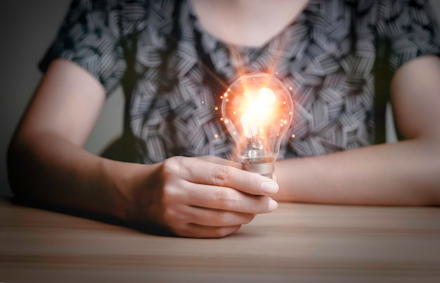 Businesswoman holding a light bulb Creative new idea Innovation brainstorming solution and inspiration concepts imagination creative thinking problem solvingxD