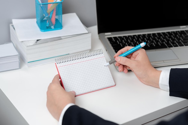 Businesswoman Holding Pen And Note With Important Message With One Hand Woman Having Notebook With Crutial Information Executive Showing Critical Data On Paper