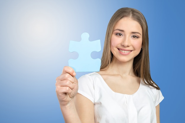 Businesswoman holding puzzle pieces