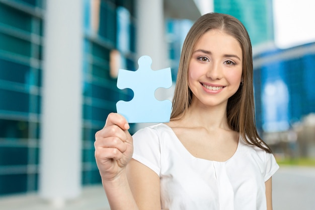 Businesswoman holding puzzle pieces